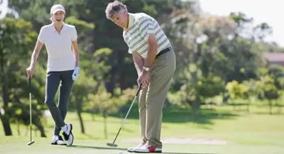 Photo of 2 people playing golf