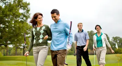 Photo of 4 people playing golf